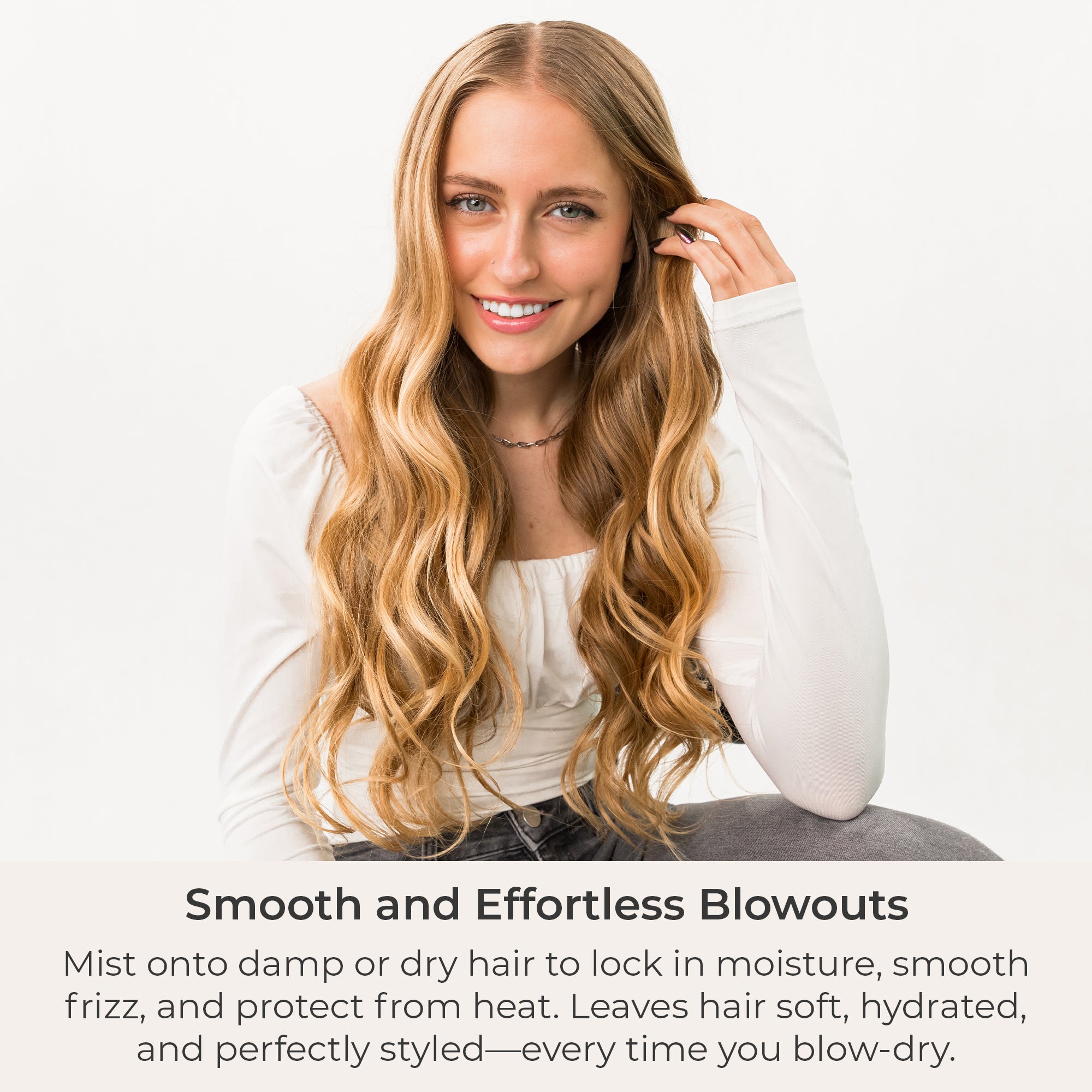 Woman with long, wavy hair posing against a white background with text about smooth and effortless blowouts.